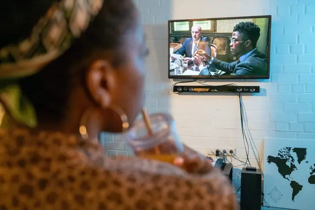 Couple relaxing while watching television at home