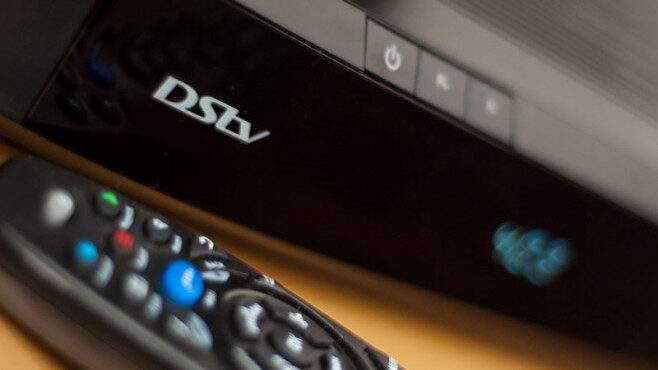 Satellite technician testing LNB output during a DStv signal diagnosis
