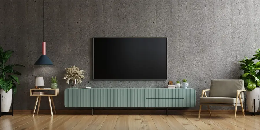 OLED television mounted on a lounge wall showing a bright picture