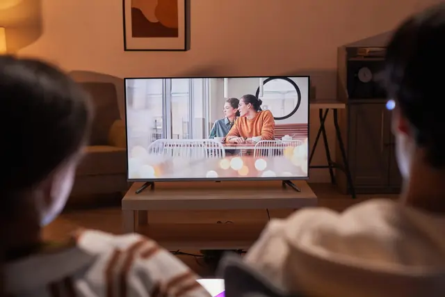 Family watching television together at home