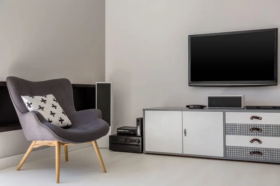 Modern television in the corner of a living room, switched off