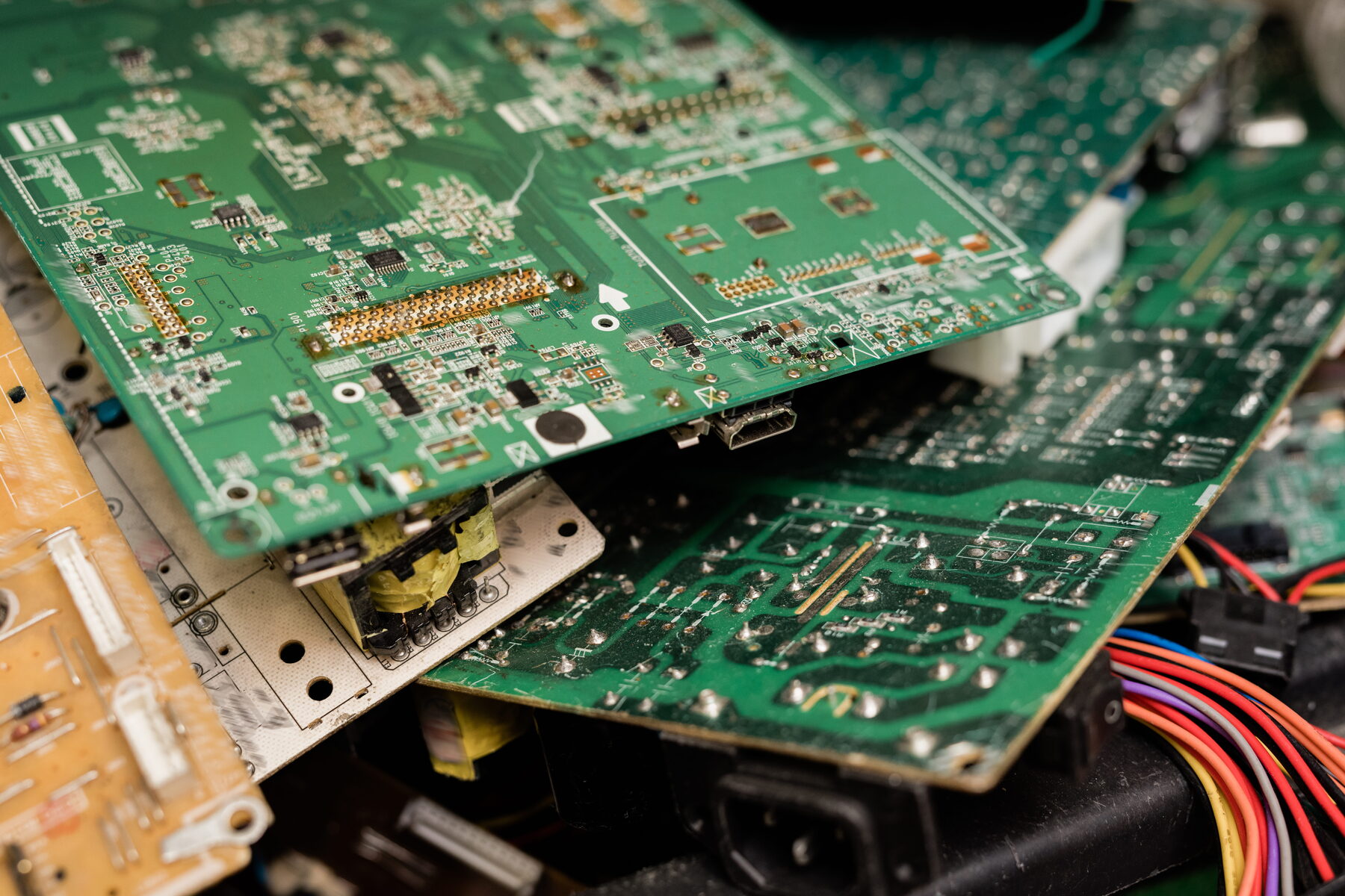 Television circuit boards being repaired at component level in a TV repair workshop