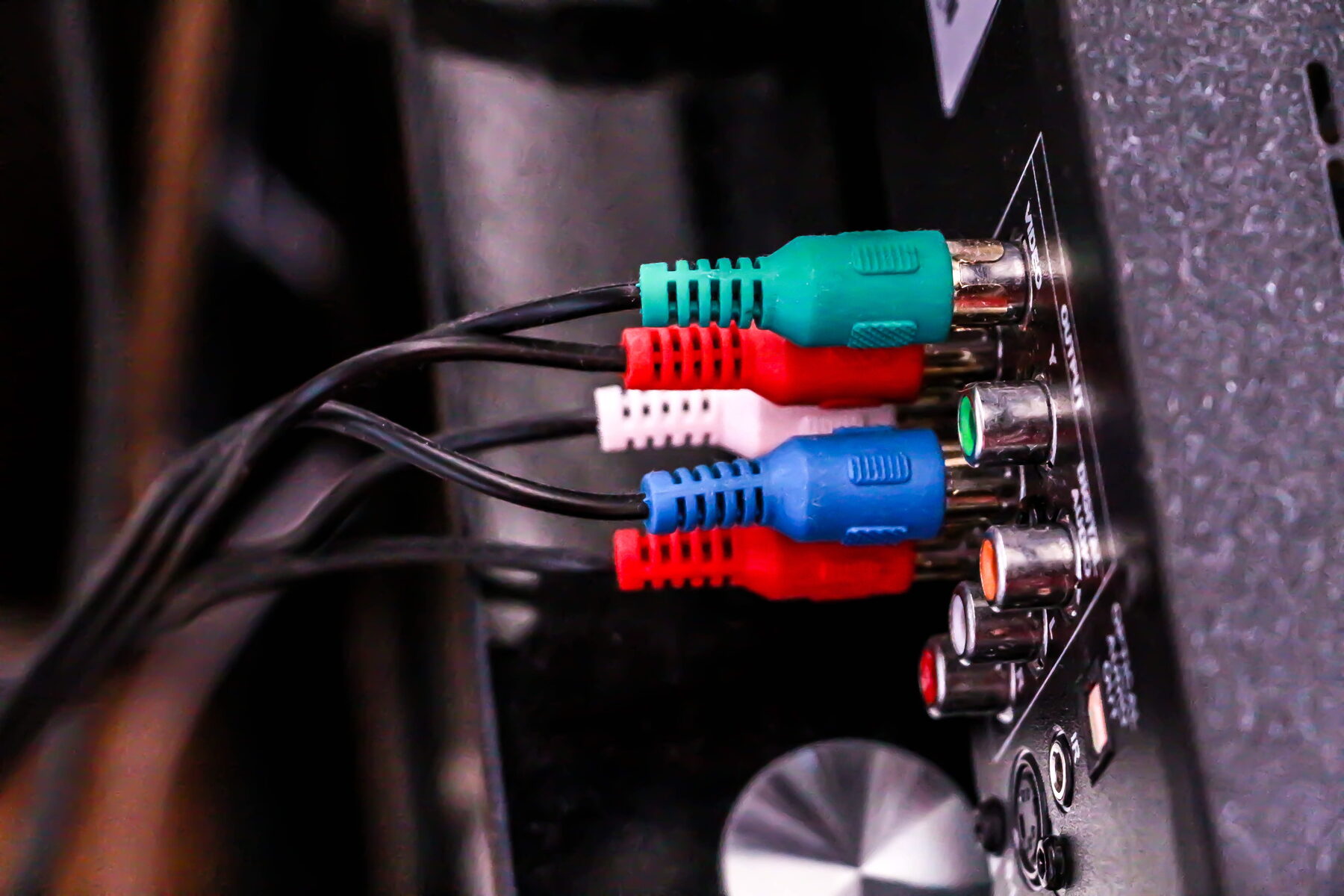 HDMI and AV cables plugged into the input ports on the back of a television